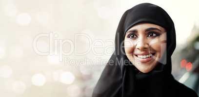 The future looks bright. an attractive young businesswoman dressed in Islamic traditional clothing standing on her office balcony.