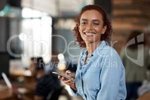 Clients appreciate the connection I keep with them. Portrait of an attractive young businesswoman using a cellphone in an office.
