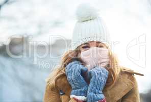 Im feeling covered and warm, now to enjoy the snow. an attractive young woman enjoying being out in the snow.