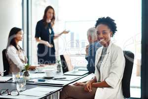 Happy assistant or intern looking cheerful in a team planning meeting at work. Portrait of a proud employee with colleagues as they discuss new innovative plans and strategy in a corporate office