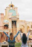 Lets be kids again and go to an amusement park. Rearview shot of two unrecognizable female best friends at an amusement park outside.