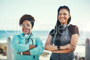 Were choosing to make healthy a habit. Portrait of two sporty young women standing on the promenade.