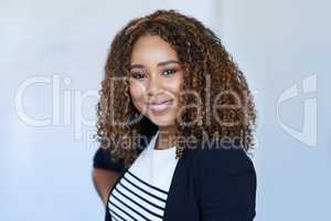 Positively professional. Cropped portrait of an attractive young businesswoman standing in her office.