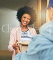 Thank you for getting it to me so quickly. a young woman receiving her delivery from the courier.