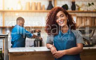 Come in and make yourself at home. Cropped portrait of an attractive young woman standing in her coffee shop.