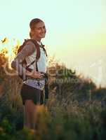 I couldnt be happier getting away from it all. Portrait of a young woman out on a hike through the mountains.