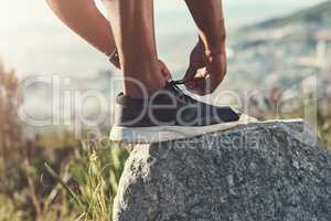 Running begins with the correct sneakers. an unrecognizable male runner tying his shoelaces outdoors.