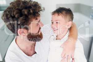 Mornings are the time to get fresh for the day. a young handsome father drying his adorable little son after a bath in the bathroom at home.