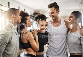 No buddy like a gym buddy. a group of happy young people working out together in a gym.