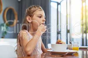 Now this is yum. an adorable little girl enjoying a meal at home.