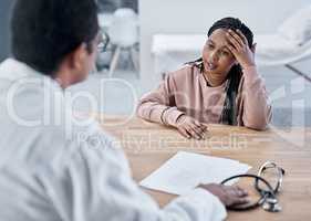 Sick, ill or stressed patient with doctor talking in medical consultation, checkup or visit in clinic, hospital or healthcare center. Tired woman with headache explaining symptoms to professional gp