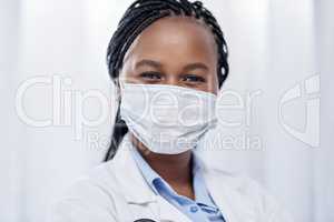 Doctor wearing hygiene face mask for covid, safety and precaution in the healthcare industry. Portrait and face of confident black medical practitioner and coronavirus frontline worker in a hospital