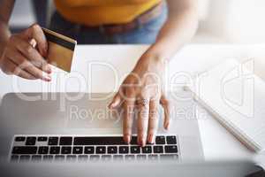 Purchasing items for the office online. High angle shot of an unrecognizable female designer using a laptop in her home office.