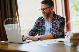 Lets start the day with some work from home. a handsome mature man using a laptop at home.