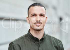 Closeup face of a serious, motivated and ambitious man standing outside in a city, town or downtown alone. Portrait, headshot and face of social worker or volunteer looking forward with trust or care