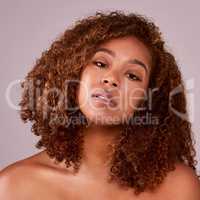 Real women rock their natural hair. Studio shot of a beautiful young woman posing against a pink background.