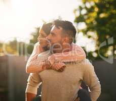 Love each other is the greatest thing people do. a happy young couple enjoying a piggyback ride outdoors.