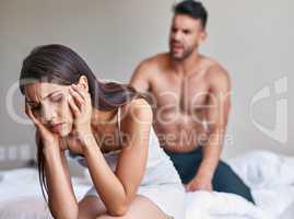 This is not the way to sort out differences. a husband arguing while his wife covers her ears in their bedroom at home.