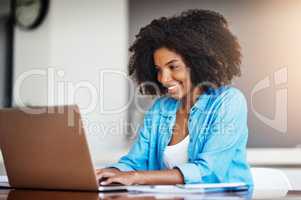 Wake up and work for it, its that easy. an attractive young woman working on her laptop at home.