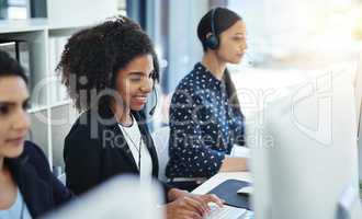 Leave it to us to fix. young women working in a call centre.