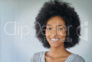 Career fulfillment is vital for your happiness. Portrait of a confident young businesswoman against a grey background.