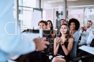 Information that inspires inspiration. a group of businesspeople clapping during a conference.