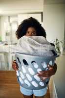 Daily chores, Im ready for you. an attractive young woman doing the laundry at home.