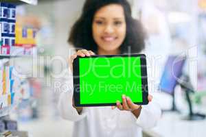 We offer fast and convenient advice online. a pharmacist holding up a tablet with a chromakey screen.