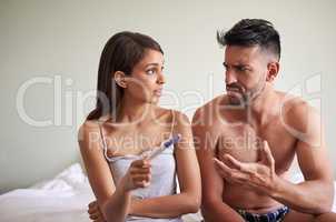 What are we going to do. a young married couple waiting for the results of a pregnancy test in their bedroom at home.
