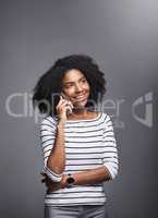 Some feelings just cant be expressed via text. Studio shot of a young woman using a mobile phone against a gray background.