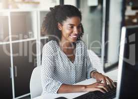 Translating her dedication into success. a young businesswoman working on a computer in an office.