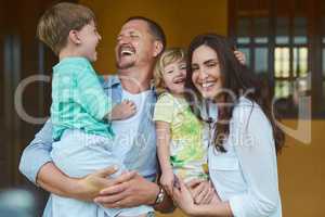 Bonding with family is what they live for. a young happy family spending time together in the backyard at home.