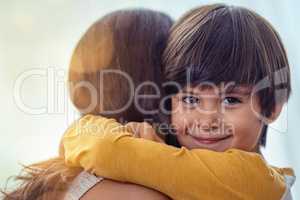 That mother son bond has always been a special one. an adorable little boy affectionately hugging his mother at home.