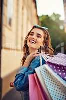 Shopping always makes me feel cheerful. a beautiful young woman on a shopping spree in the city.