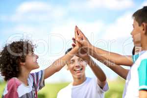 You can always count on siblings to keep you motivated. a group of happy siblings giving each other a high five outdoors.