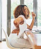 Shes feeling all this hard work. a young attractive businesswoman experiencing body discomfort in her office at home.