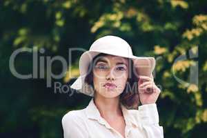Beauty so sublime. Portrait of an attractive young woman wearing a stylish hat outdoors.