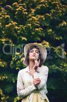 She makes a statement no matter the season. Portrait of an attractive young woman wearing a stylish hat outdoors.