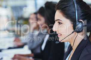 Youve reached our customer care, how may I assist. a young woman working in a call centre.