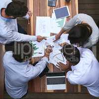 Pointing out the faults to fix them. High angle shot of a team of businesspeople having a meeting outside.