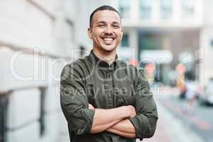 Business man standing with arms crossed, looking confident and proud in the city alone. Portrait of a black male entrepreneur or worker showing vision, ambition and success with arms folded downtown