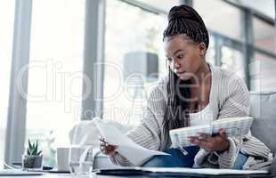 Planning finance, budget and savings with paperwork, bank document and investment report in home living room. Serious, thinking woman reading student loan information and calculating financial future