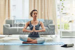 Become stronger mentally and physically with yoga. an attractive young woman practicing yoga at home.