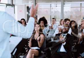 Taking his audience on a journey theyll never forget. a group of businesspeople clapping during a conference.