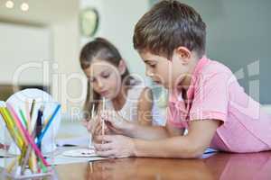 Theyre crafty kids. two adorable little siblings painting together at home.