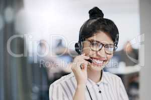Ready to go the extra mile for any customer. Portrait of a young call centre agent working in an office.