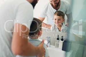 My little boy is getting big, reaching the basin already. an unrecognizable father helping his adorable little boy wash his hands in the bathroom at home.