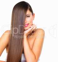 No, you arent imagining things, her hair is that perfect. Studio portrait of a beautiful young woman posing against a white background.