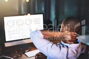 Trying to make sense of these numbers. Rearview shot of an unrecognizable young businessman experiencing tension while using a computer to look at graphs late at work.