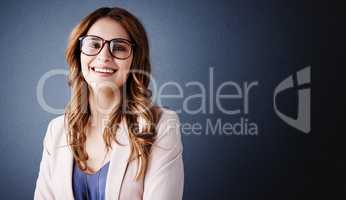 Let your Positive about my place in the business world guide you. Studio portrait of an attractive and confident young businesswoman posing against a dark blue background.
